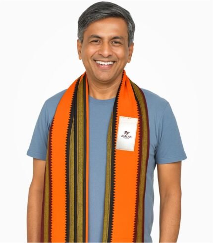 Indian male model wearing orange Madrasi gamcha with green and golden border, smiling in white studio background