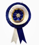 Blue and white two-layer ribbon badge with floral silver center