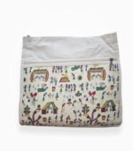 Front view of canvas shoulder bag with colorful Warli art print