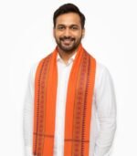 Indian man wearing orange sanskar gamcha with traditional border design – front view in white kurta