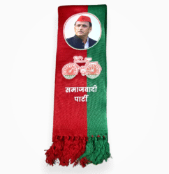 Folded red and green Samajwadi Party muffler with Akhilesh Yadav's photo and bicycle symbol.