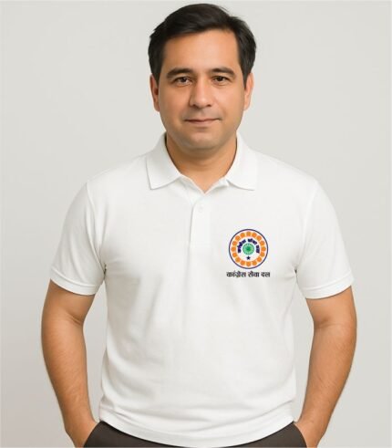 Indian man wearing a white Congress Seva Dal polo t-shirt with logo on chest