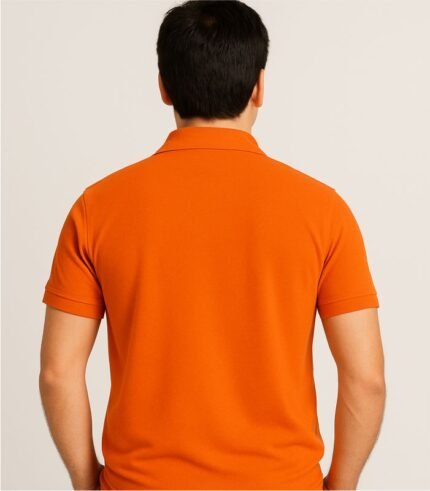 Back view of plain orange collared polo t-shirt worn by Indian male model