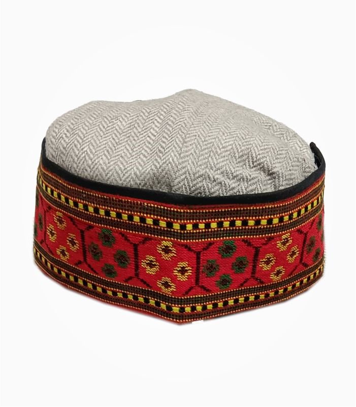 Colorful Himachali cap with red embroidered floral border and grey crown.