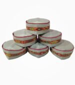 Stack of Himachali caps with traditional center embroidery in red, green, and yellow threads.