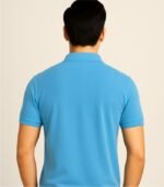 Back side of sky blue polo t-shirt worn by male model in studio