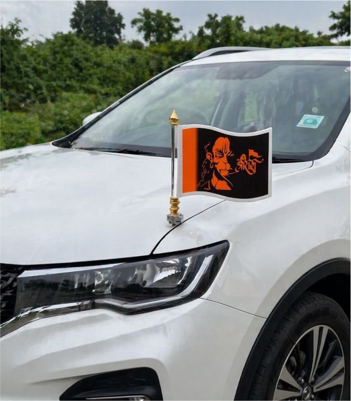 Hanuman Ji black orange car bonnet flag mounted on metal rod on white SUV hood