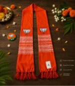 BJP Orange Rajwadi Muffler on wooden table with lotus print and woven cotton design by Jhalak Enterprises