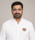 Indian man wearing BJP Kamal Stone Badge on white kurta