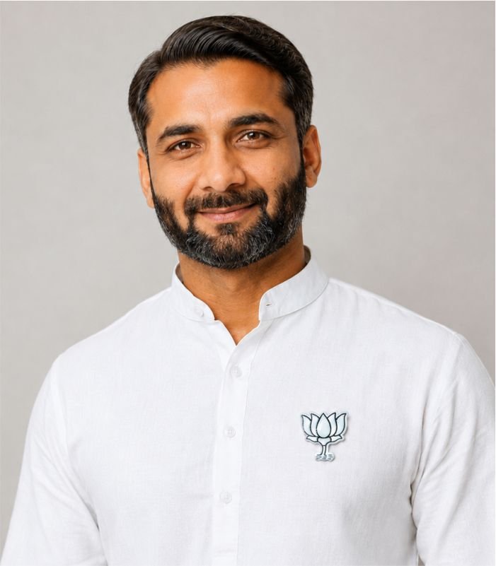 Smiling Indian man wearing BJP White Kamal Badge on white kurta