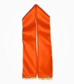 in orange satin patka with narrow golden lace and fringe at both ends