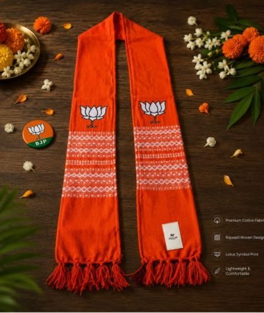 BJP Orange Rajwadi Muffler on wooden table with lotus print and woven cotton design by Jhalak Enterprises